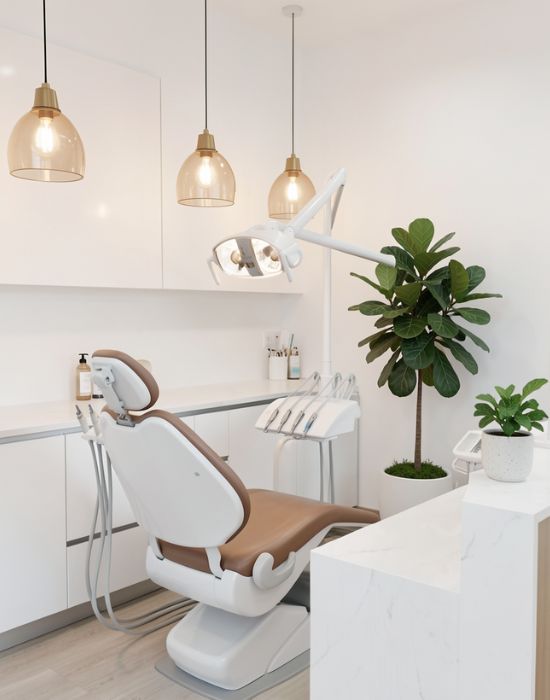 Dental treatment room at NuSmile Implant Studio featuring a modern dental chair, advanced lighting, and greenery, emphasizing a comfortable and welcoming environment for cosmetic smile restoration and dental implants.